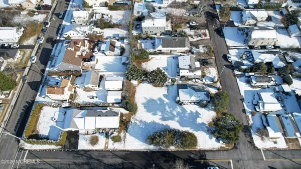 an aerial view of residential building with parking