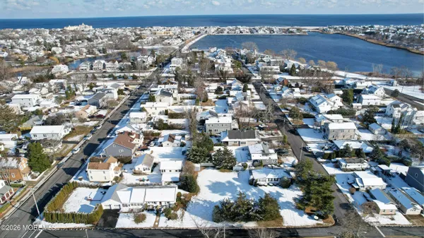 a front view of a house with yard covered in snow