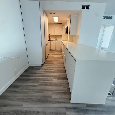 a view of a room with wooden floor and stairs