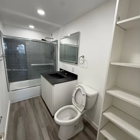 a view of a room with wooden floor