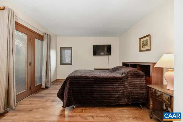 a view of a hallway with wooden floor and stairs