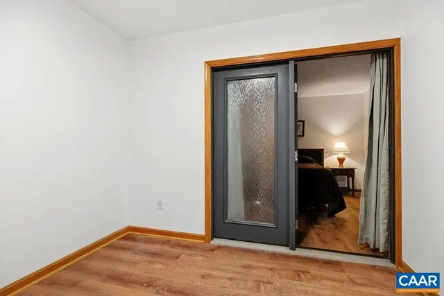 a view of a small space with wooden floor and closet