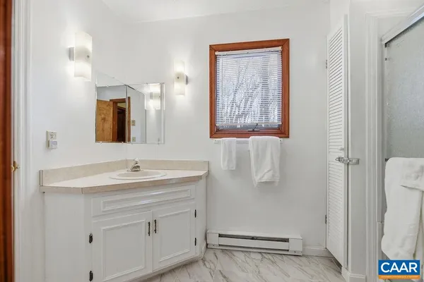 a bedroom with a bed and a chair