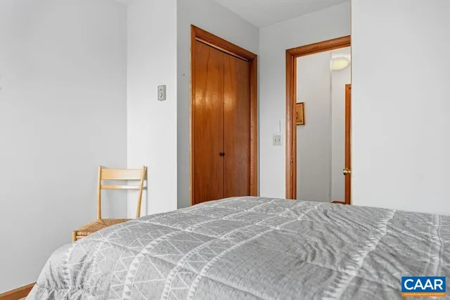 a bedroom with a bed and a chair