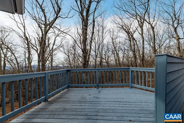 a terrace view with wooden floor and fence