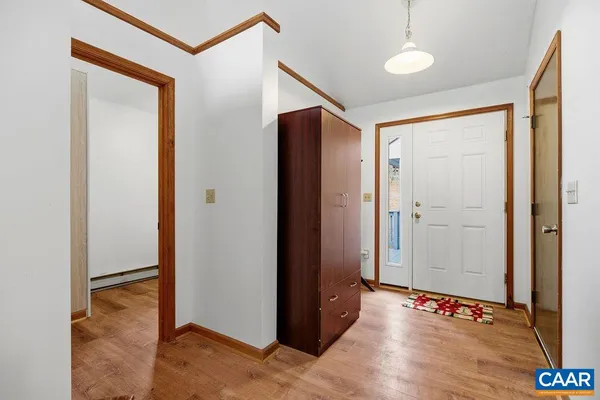 a kitchen with a refrigerator a stove top oven a sink and dishwasher with wooden floor