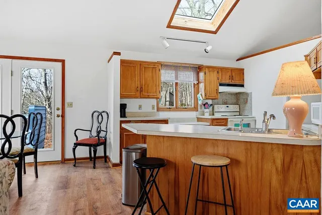 a kitchen with stainless steel appliances granite countertop a sink and a refrigerator