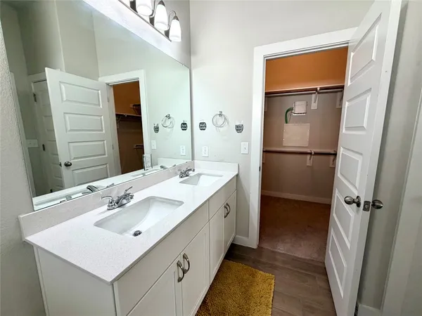 a bathroom with a sink a mirror and a shower