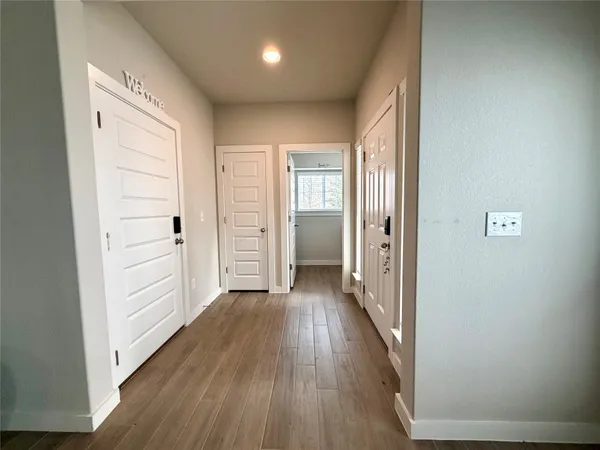 wooden floor in a hall with an empty room