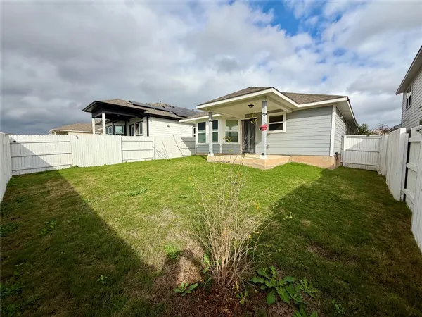 a front view of a house with yard and green space