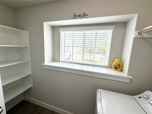 a bathroom with a window a toilet and a window