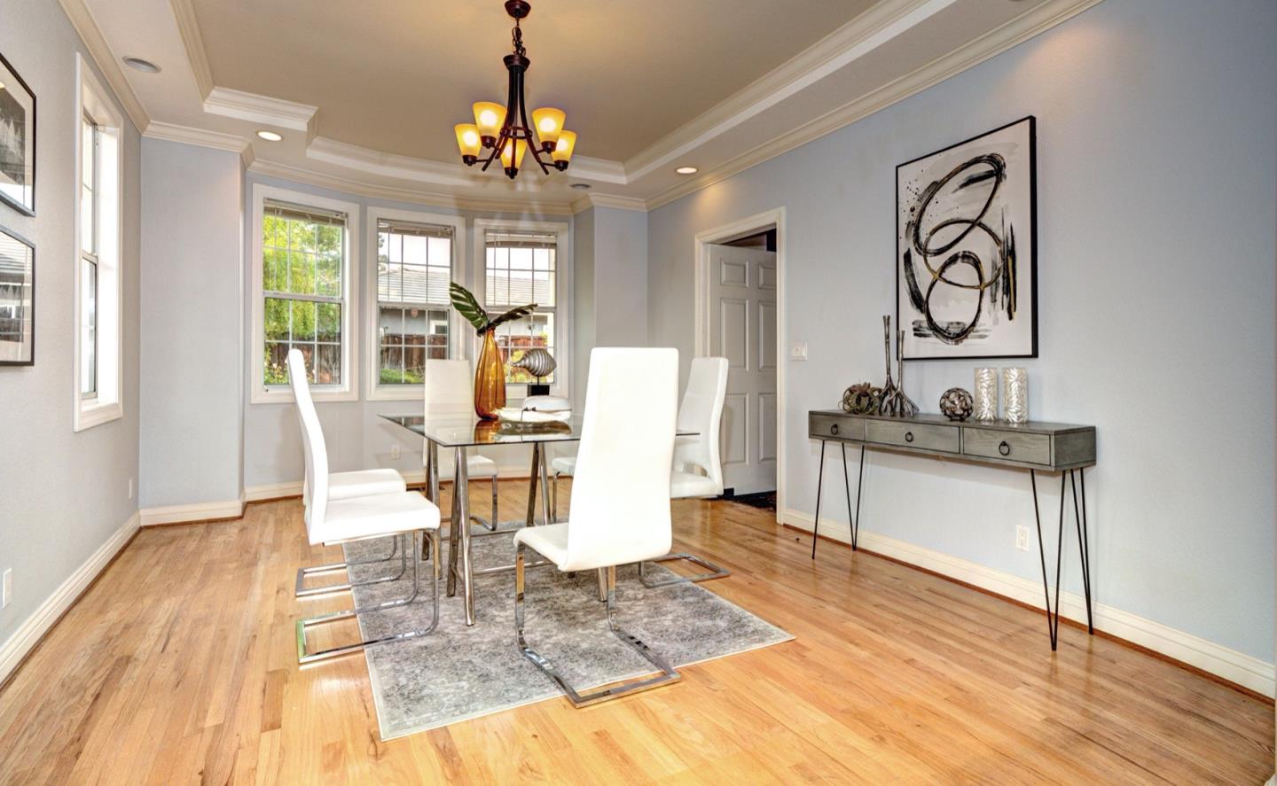 10171 Carmen Road Cupertino, CA 95014 - Photo 13 of 42 a view of a dining room with furniture wooden floor and chandelier