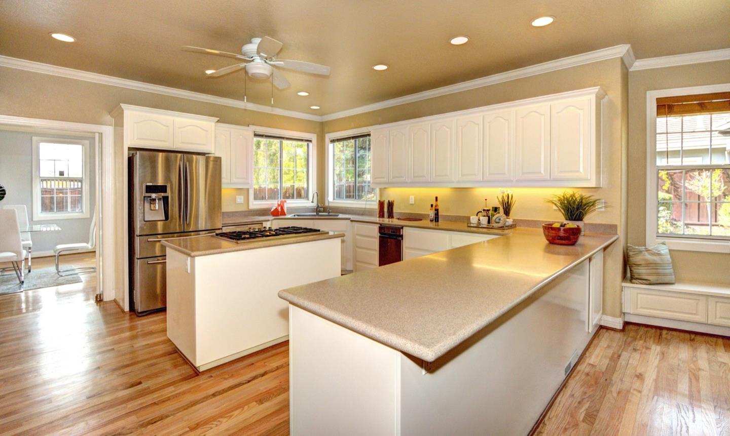 10171 Carmen Road Cupertino, CA 95014 - Photo 16 of 42 a kitchen with a refrigerator a sink dishwasher and a stove with wooden floor