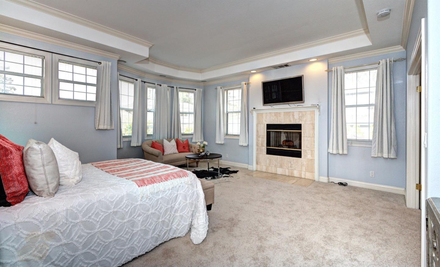 10171 Carmen Road Cupertino, CA 95014 - Photo 26 of 42 a bedroom with bed and a flat screen tv