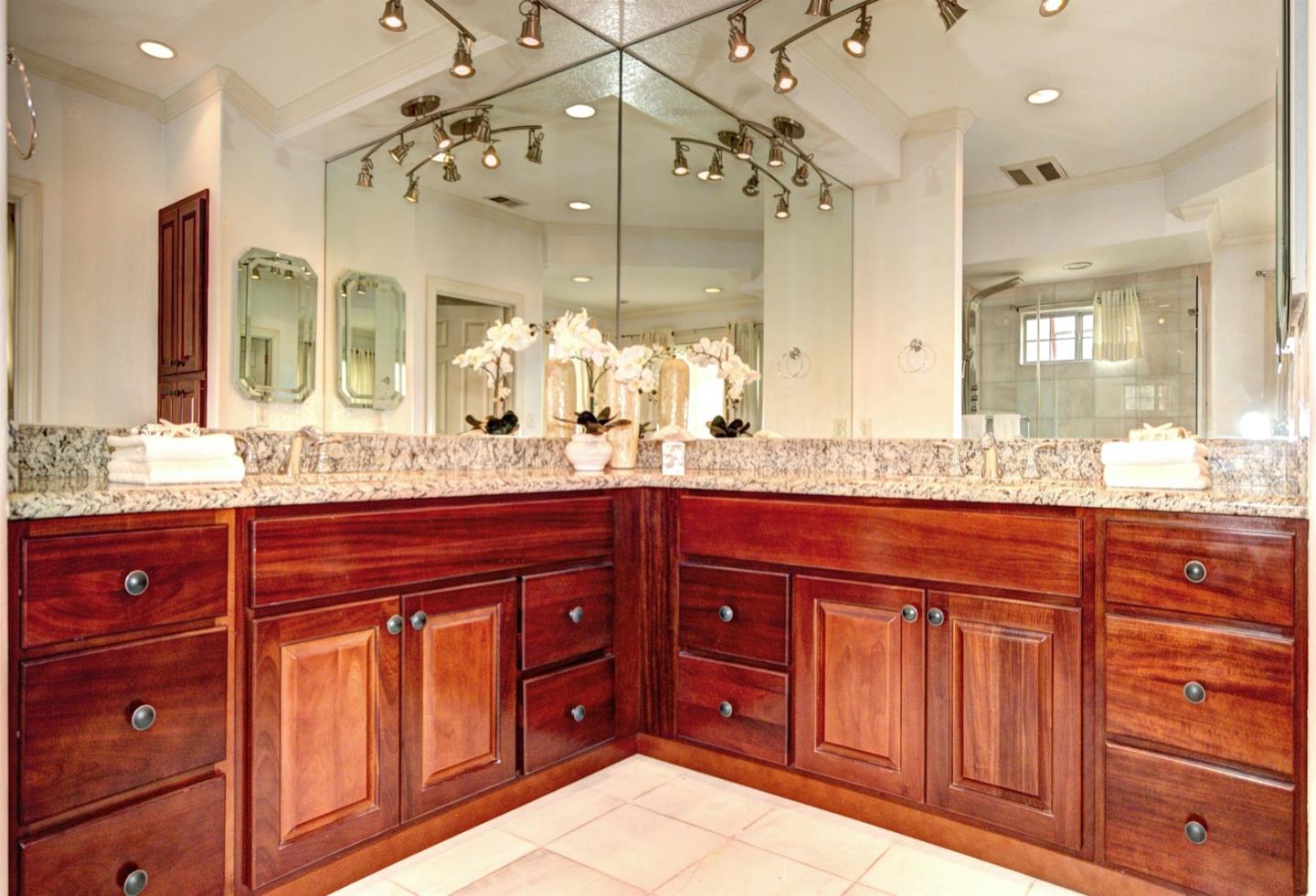 10171 Carmen Road Cupertino, CA 95014 - Photo 27 of 42 a bathroom with a granite countertop sink and a large mirror