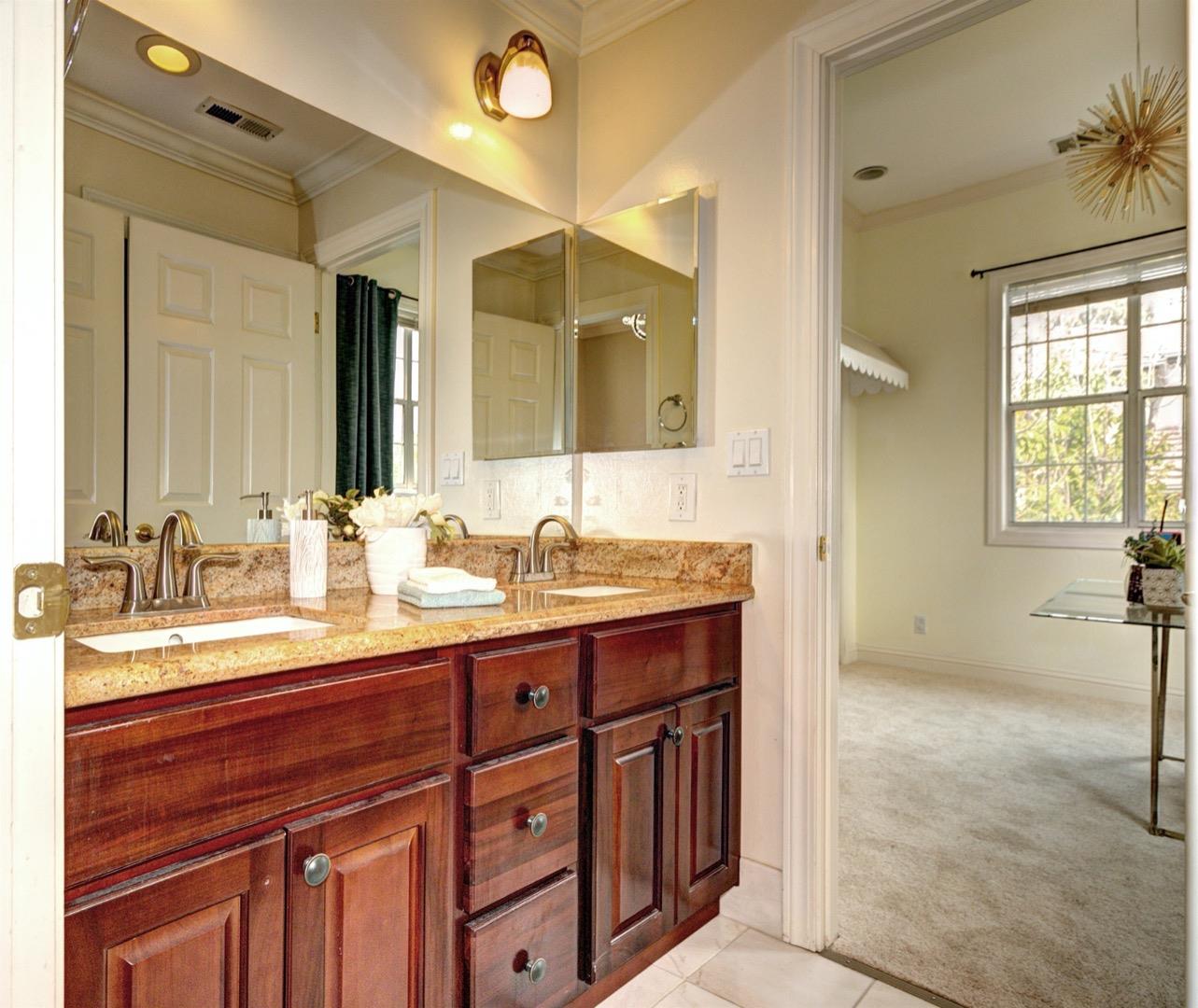 10171 Carmen Road Cupertino, CA 95014 - Photo 30 of 42 a spacious bathroom with a granite countertop sink mirror and double