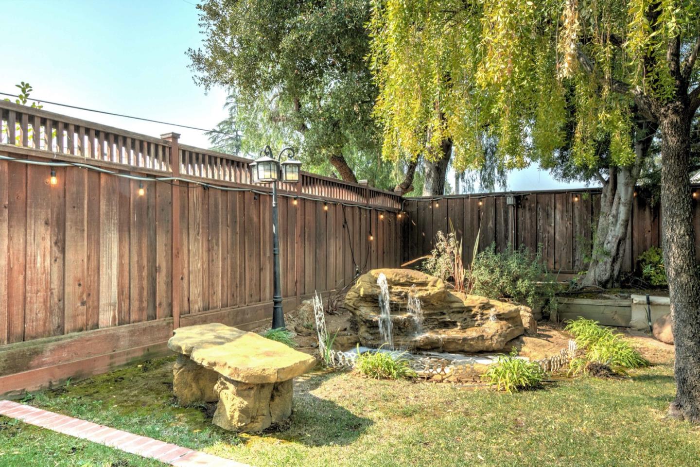 10171 Carmen Road Cupertino, CA 95014 - Photo 36 of 42 a view of a chair and table in backyard