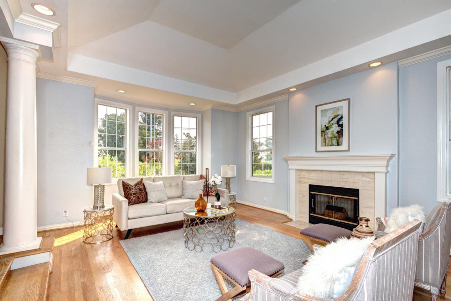 10171 Carmen Road Cupertino, CA 95014 - Photo 10 of 42 a living room with furniture and a fireplace