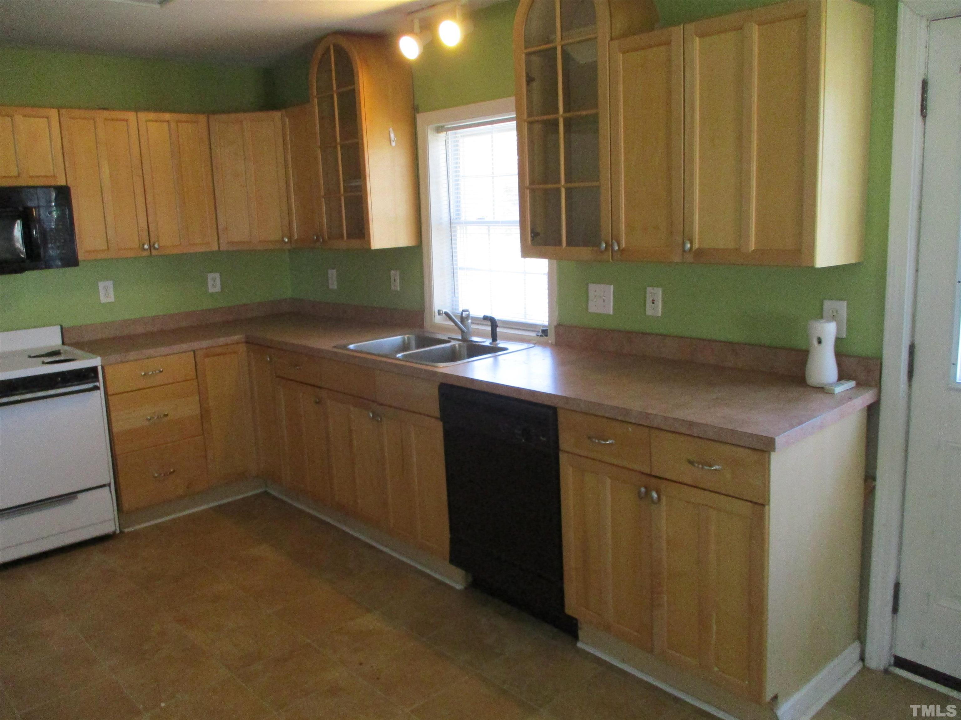 2415 Bedford Avenue Raleigh, NC 27607 - Photo 11 of 12 a kitchen with a sink cabinets and a microwave