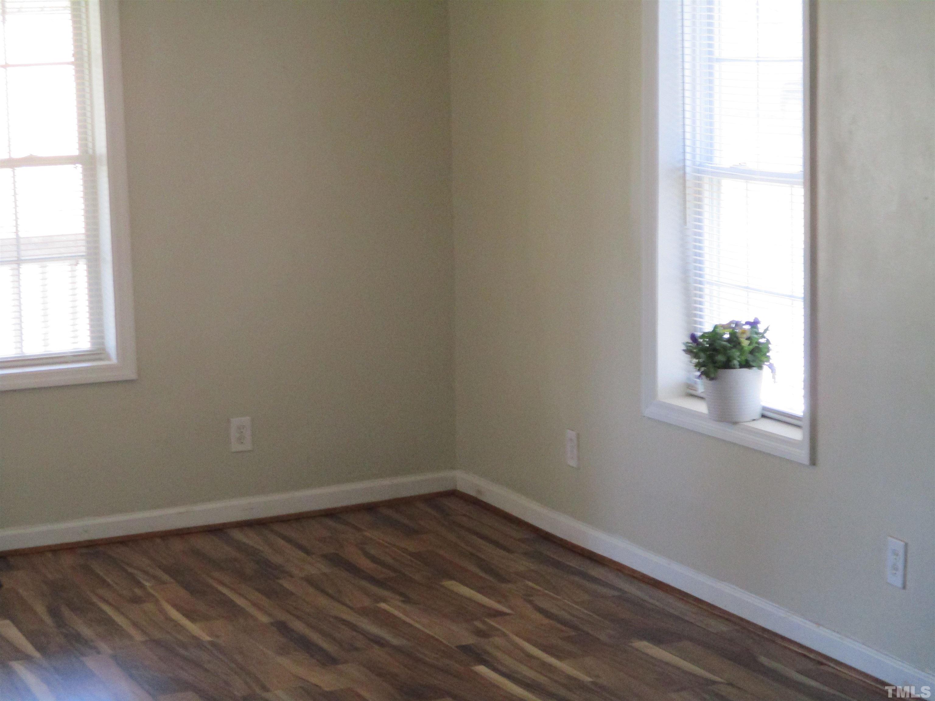 2415 Bedford Avenue Raleigh, NC 27607 - Photo 7 of 12 an empty room with wooden floor and windows