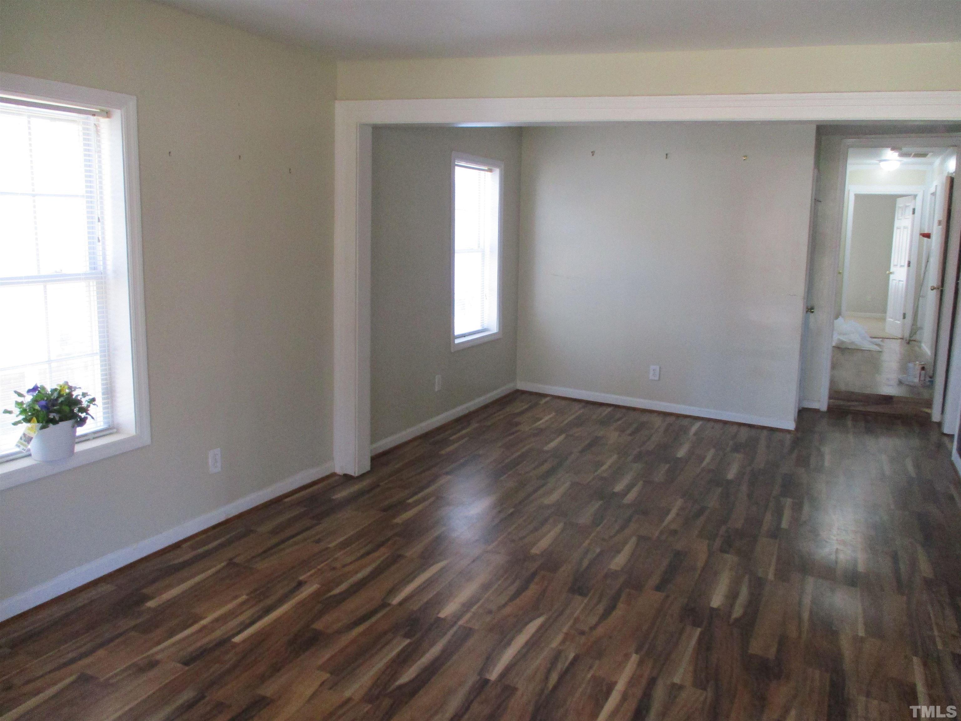 2415 Bedford Avenue Raleigh, NC 27607 - Photo 8 of 12 a view of an empty room with wooden floor and a window