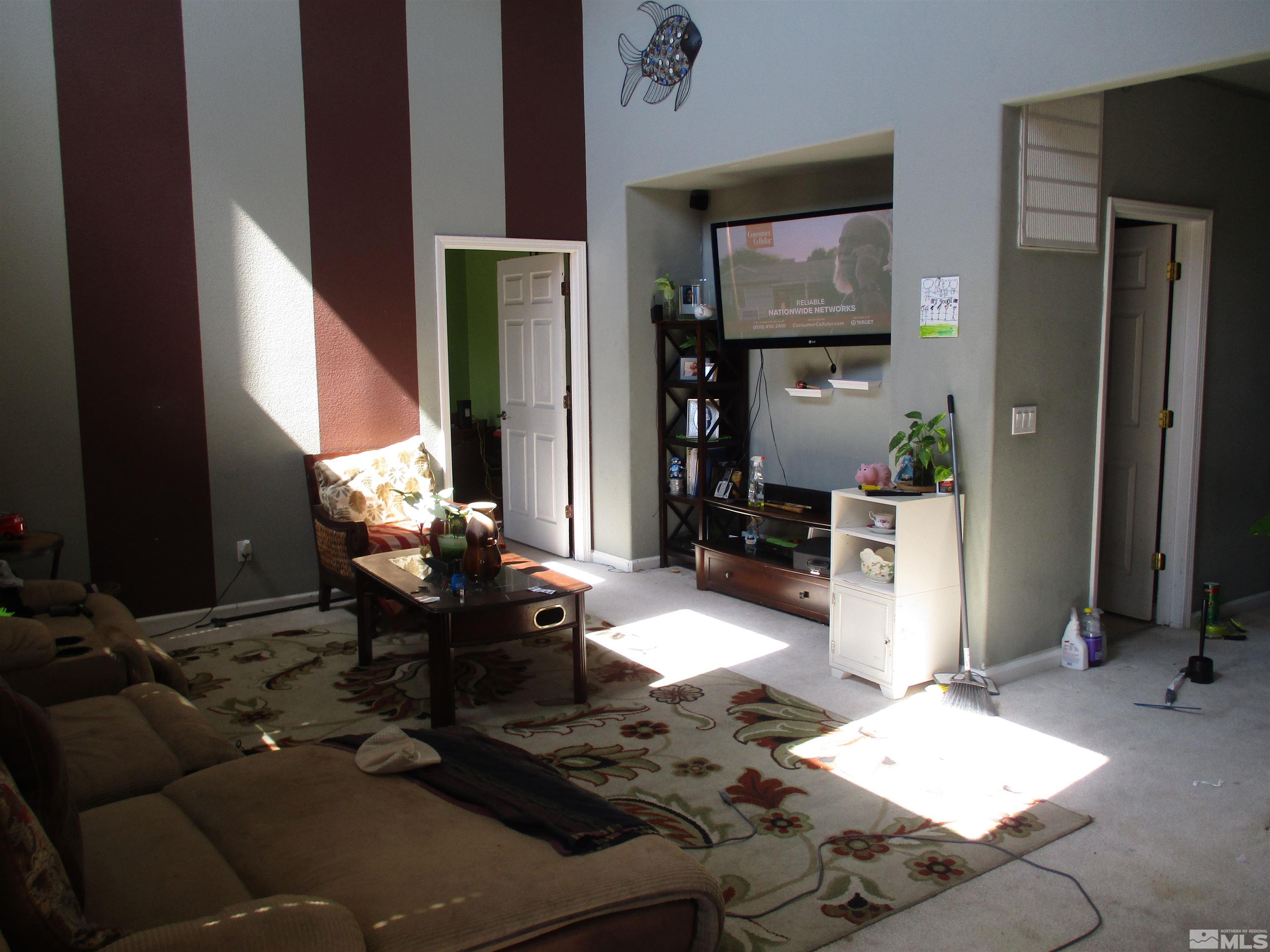 9085 Andraste Way Reno, NV 89506 - Photo 6 of 11 a living room with furniture rug and wall painting