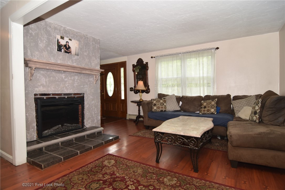 107 Bonnet Shores Road Narragansett, RI 02882 - Photo 14 of 33 Living room with wood fireplace.