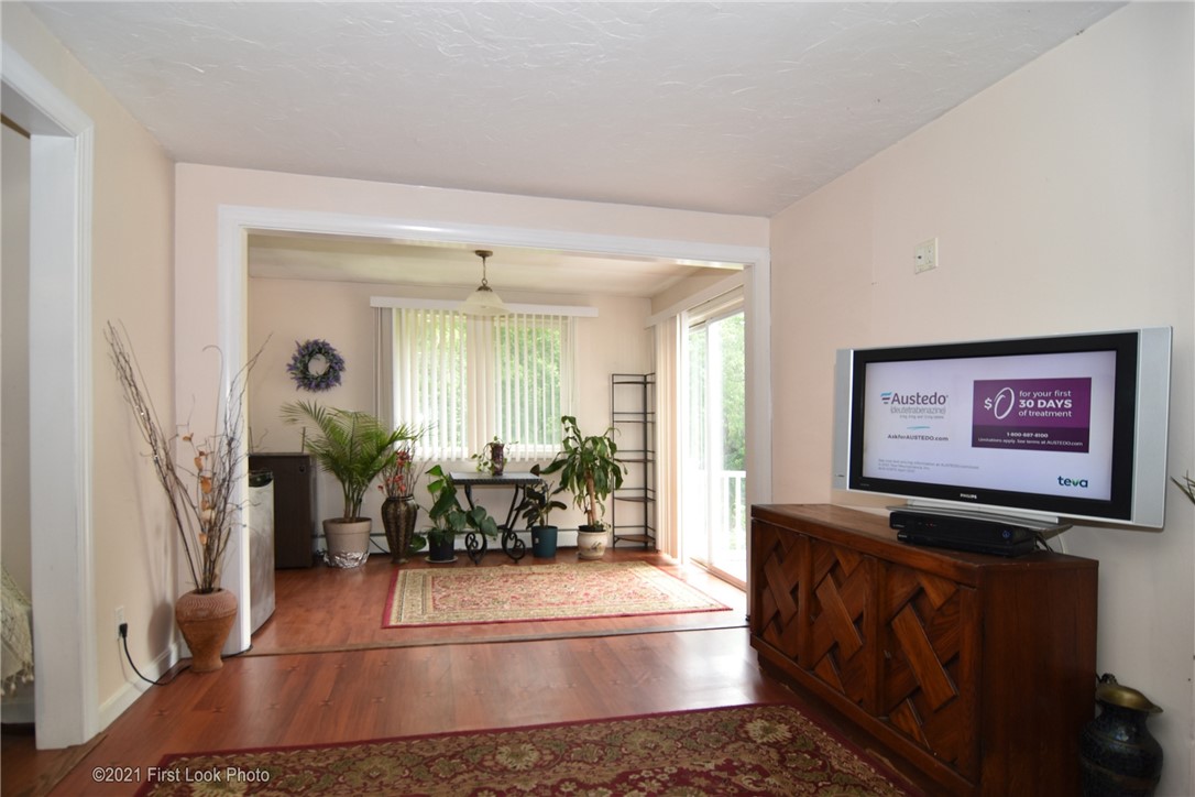 107 Bonnet Shores Road Narragansett, RI 02882 - Photo 18 of 33 Sun room with sliding door which exits to deck.