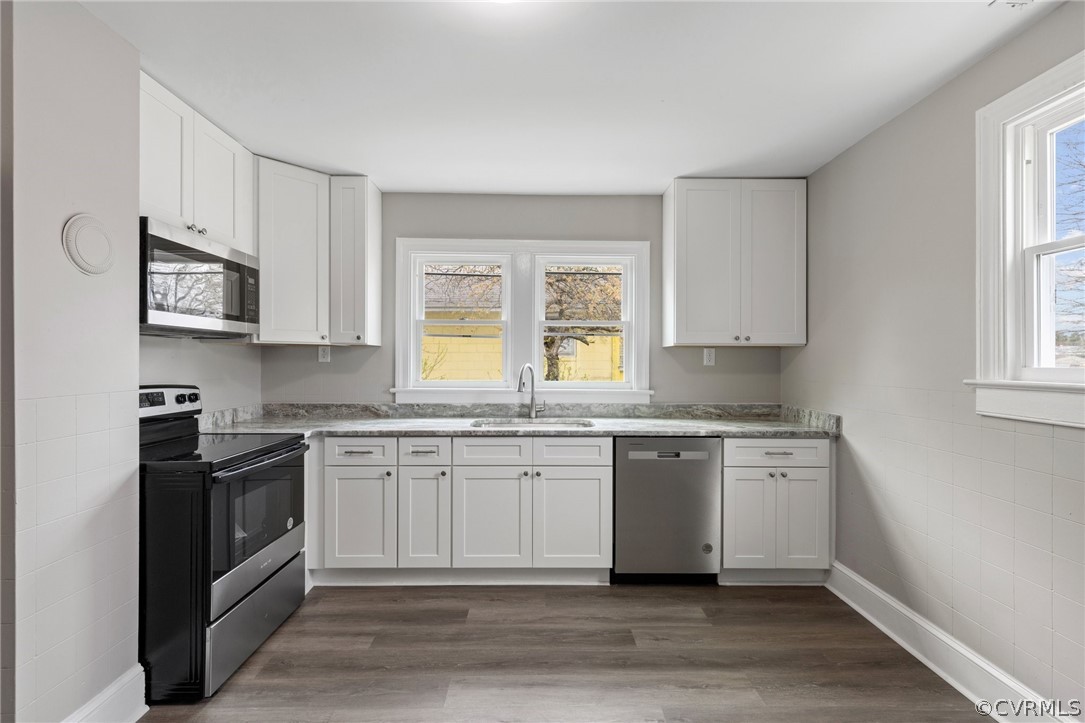 3510 East River Road Petersburg, VA 23803 - Photo 12 of 19 a kitchen with stainless steel appliances granite countertop a stove a sink and a microwave