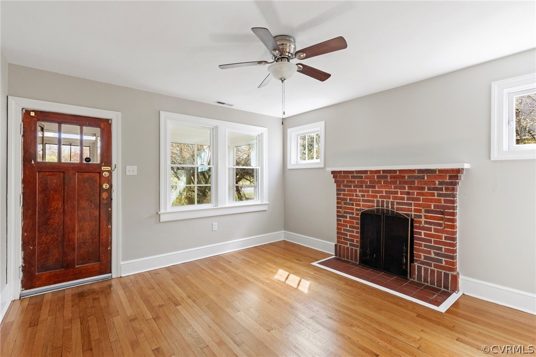 3510 East River Road Petersburg, VA 23803 - Photo 4 of 19 an empty room with windows fireplace and a sink