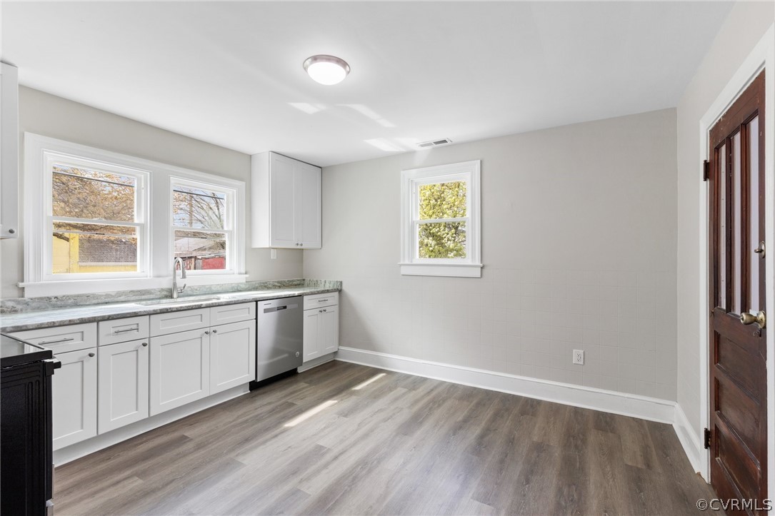 3510 East River Road Petersburg, VA 23803 - Photo 9 of 19 a large white kitchen with sink and dishwasher with wooden floor