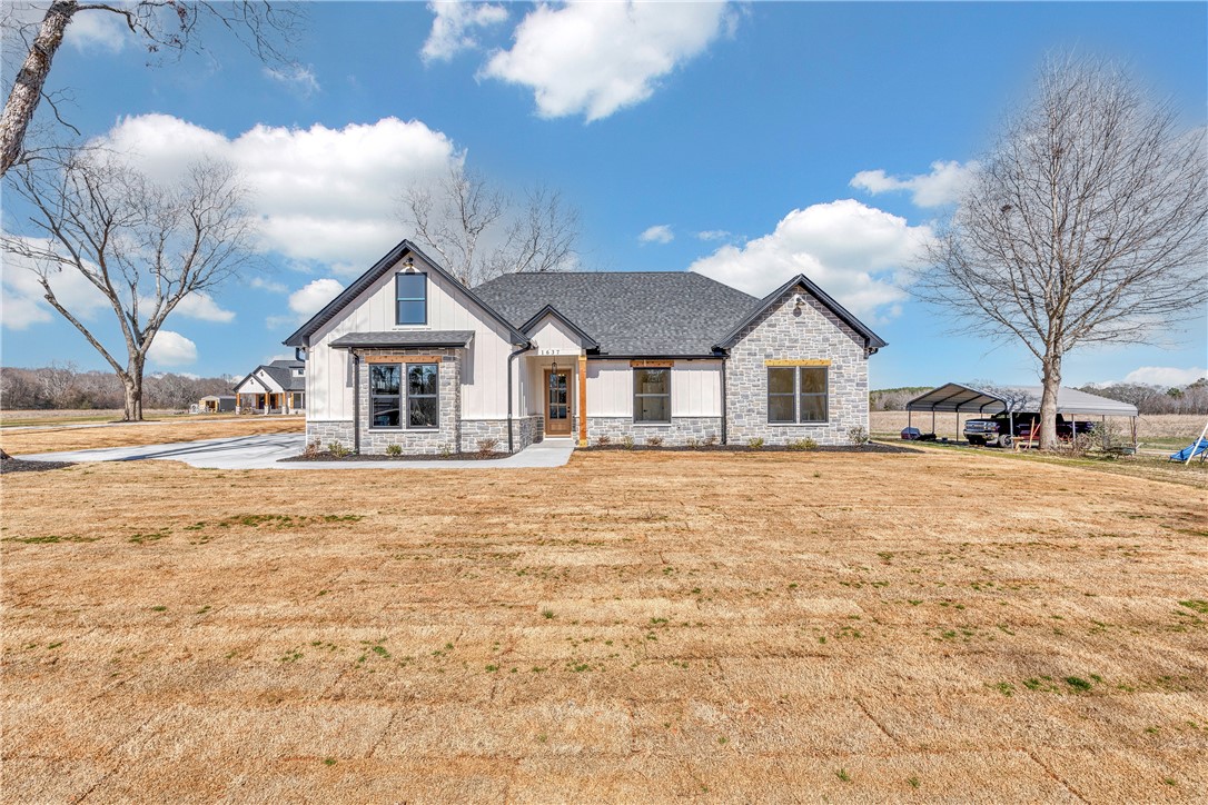 2816 Smith McGee Road Iva, SC 29655 - Photo 2 of 25 A striking modern farmhouse with stone and vertical siding offers inviting curb appeal.