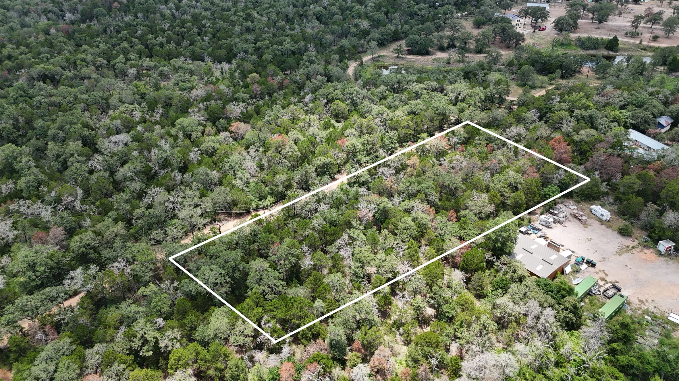 Tbd Red Fox Lane Bastrop, TX 78602 - Photo 3 of 14 A verdant parcel of land awaits your vision amidst mature trees.