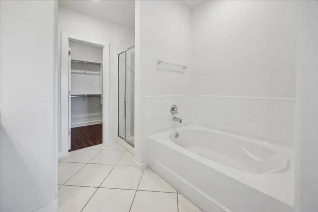 a spacious bathroom with a bathtub and a shower