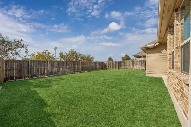 a view of a house with backyard and a garden
