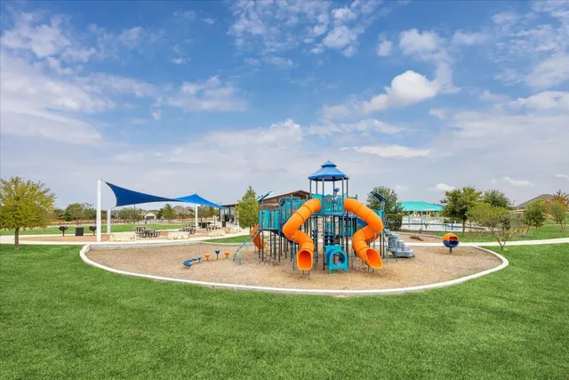 a view of outdoor space with playground and green space