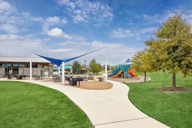 a view of yard with swimming pool and green space