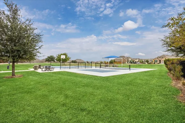 a view of green field with house in the background