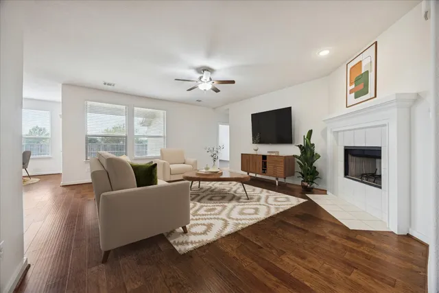 a living room with furniture fireplace and flat screen tv