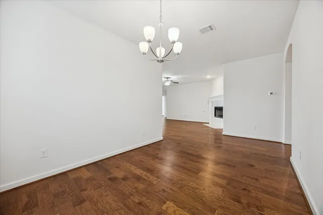 a view of a chandelier fan and wooden floor