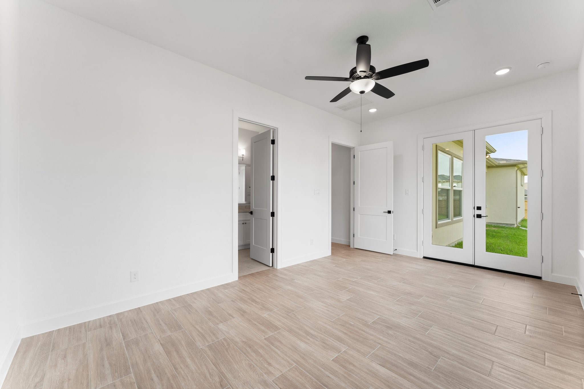 24807 Pacific Dunes Lane Spring, TX 77389 - Photo 17 of 50 a view of an empty room with wooden floor and a ceiling fan