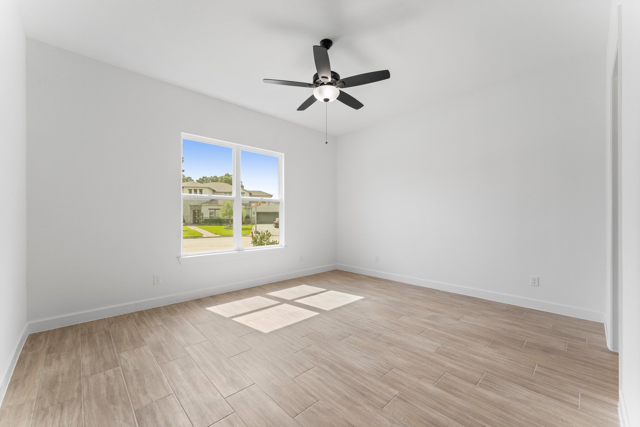 24807 Pacific Dunes Lane Spring, TX 77389 - Photo 24 of 50 wooden floor in an empty room with a window