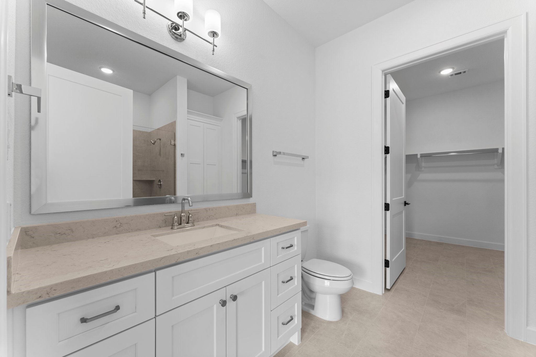 24807 Pacific Dunes Lane Spring, TX 77389 - Photo 26 of 50 a bathroom with a granite countertop toilet a sink and a large mirror