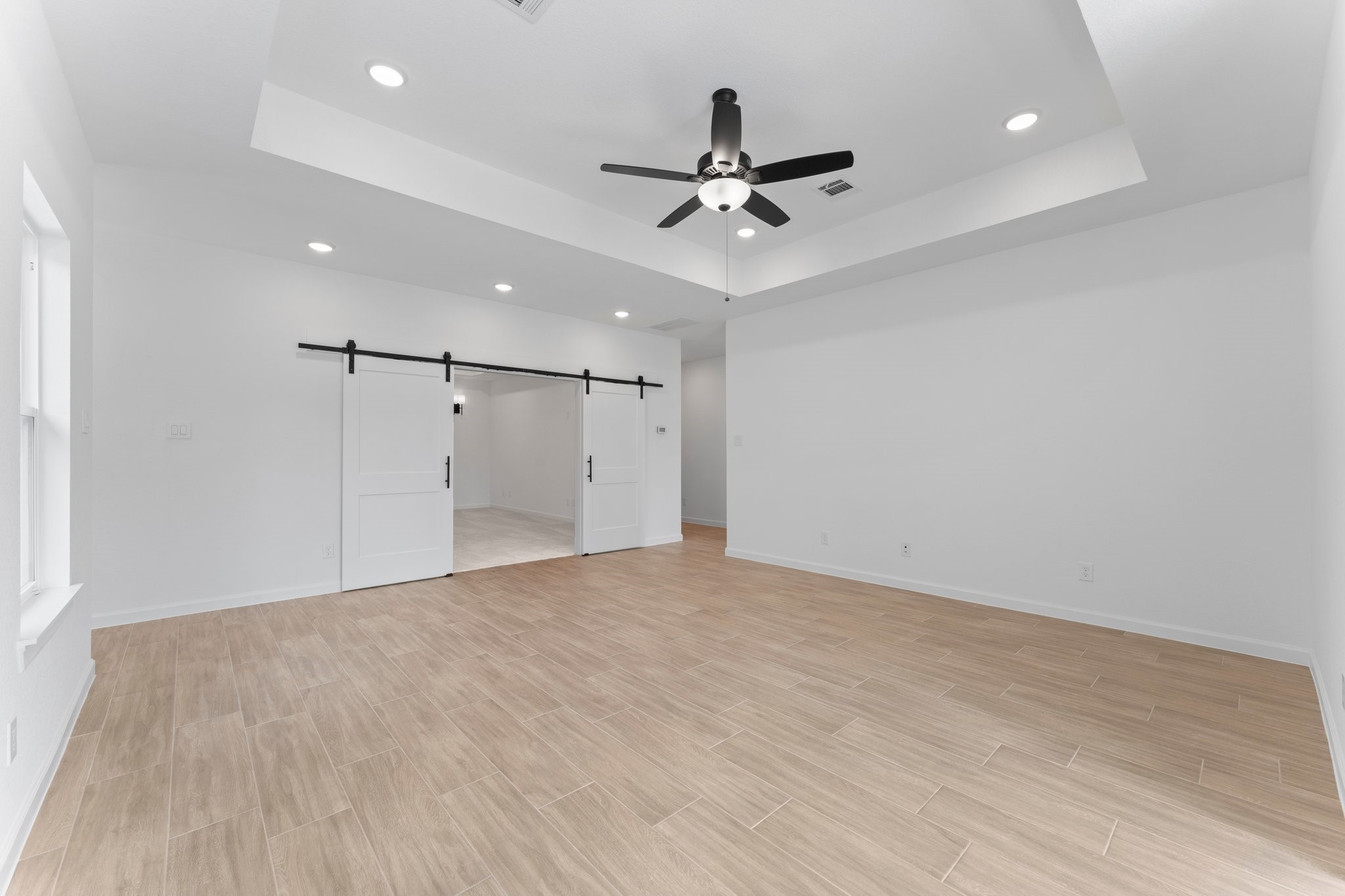 24807 Pacific Dunes Lane Spring, TX 77389 - Photo 31 of 50 a view of a livingroom with a ceiling fan & kitchen space
