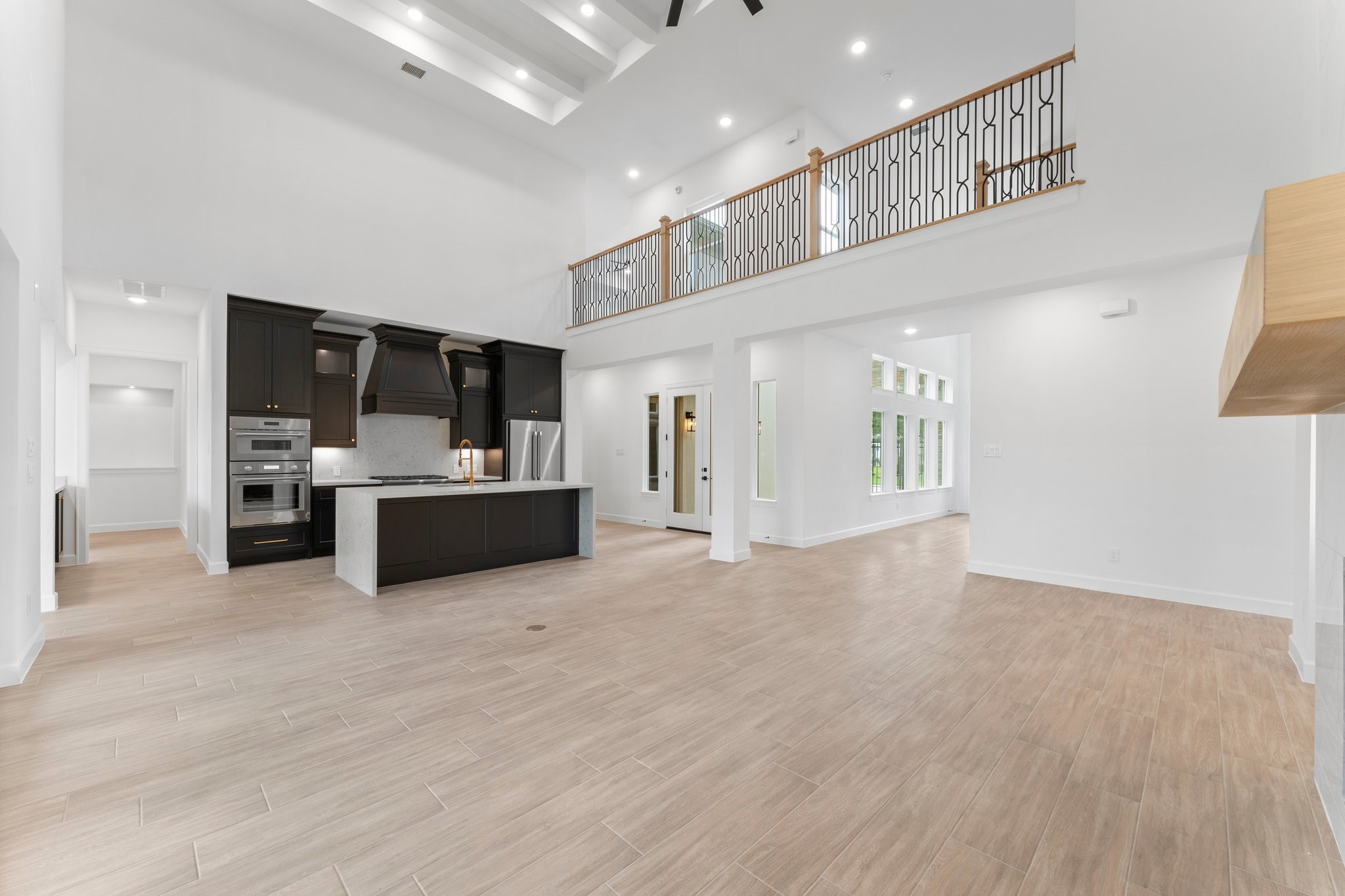 24807 Pacific Dunes Lane Spring, TX 77389 - Photo 6 of 50 a view of a kitchen with kitchen island and stainless steel appliances