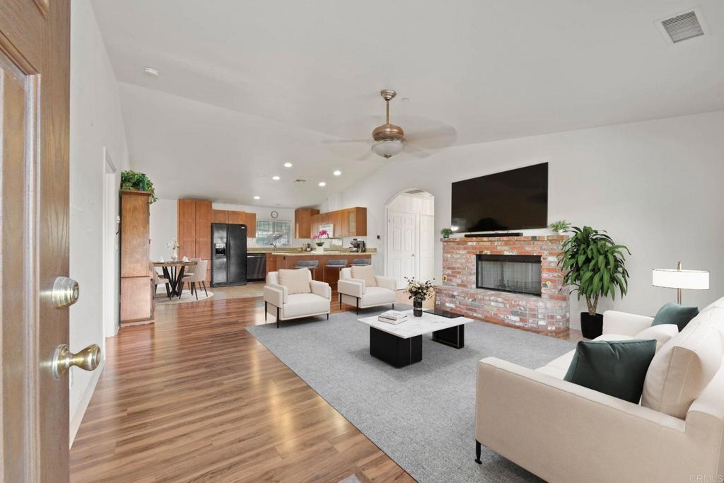 8269 West Lilac Road Bonsall, CA 92003 - Photo 1 of 1 a living room with furniture and a flat screen tv