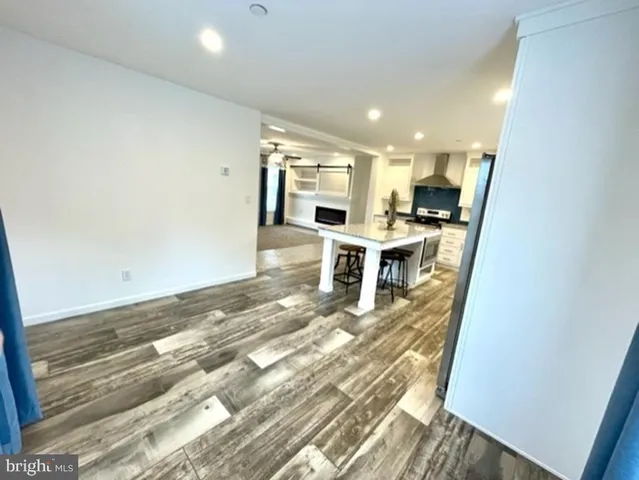 a view of a living room a dining table and chairs