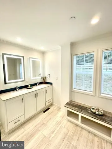 a large white kitchen with sink and window