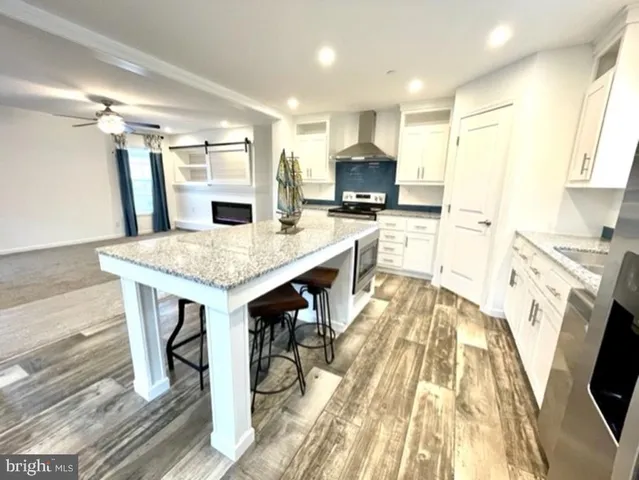 a kitchen with a table chairs refrigerator and microwave