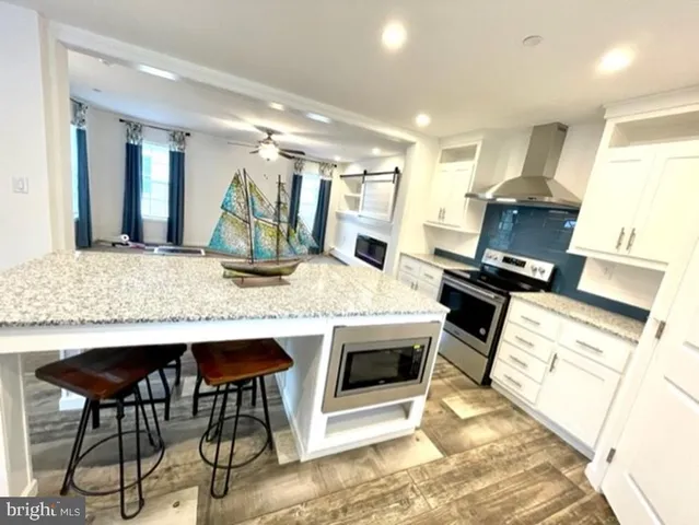 a kitchen with stainless steel appliances kitchen island granite countertop a stove and a sink